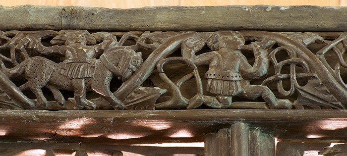 A hunting scene carved in wood