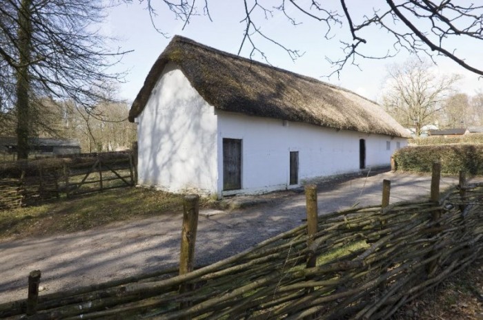 A farmhouse with a thatched roof